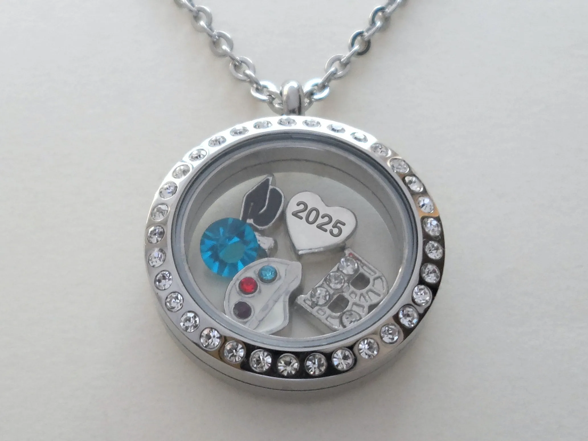 Class of 2025 Graduate Locket Necklace with Graduate Cap, 2025 Heart Charm, and Custom Letter & Birthstone - by Jewelry Everyday