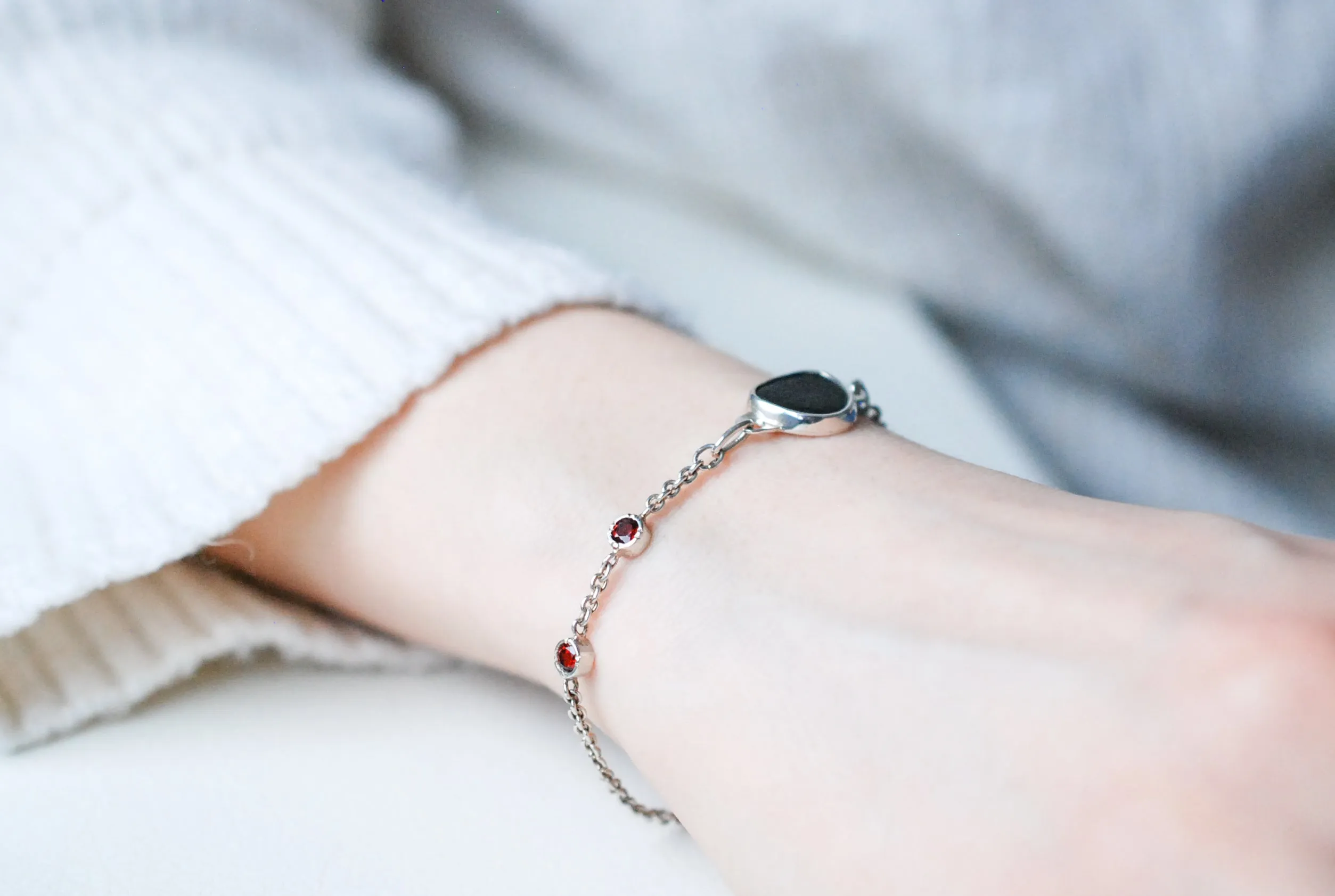 Silver bracelet with natural black stone and red garnets
