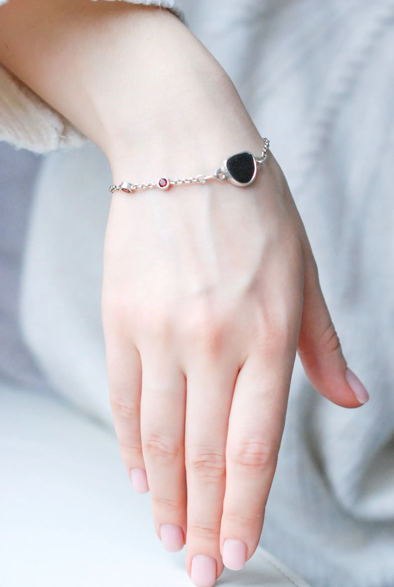 Silver bracelet with natural black stone and red garnets
